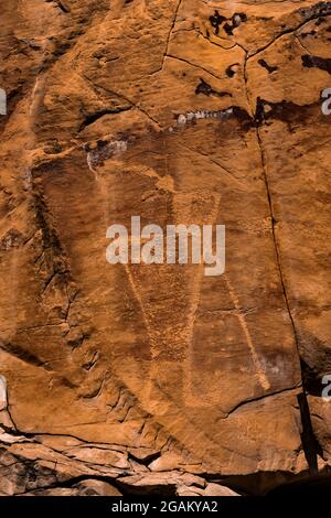 Stylized human figure, perhaps a flute player, at McKee Springs Petroglyph Site, Dinosaur National Monument, Utah, USA Stock Photo