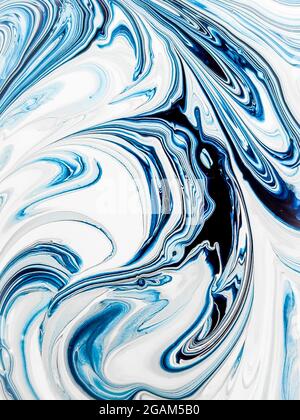 Background of an abstract blue-and-white drawing. Multi-layer pattern of mixed paint. Curved lines close up. Stock Photo