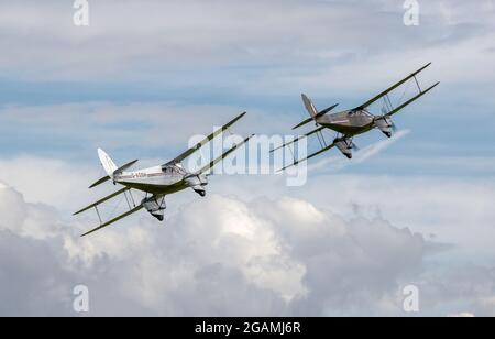 2 de Havilland Dragon Rapide ‘G-AGJG & G-AGSH’ flying in formation at Shuttleworth Flying Festival of Britain airshow on the 6th June 2021 Stock Photo