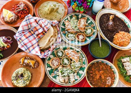 Traditional mexican dishes sopes, tacos dorados, tortillas, mole poblano, red rice, rajas poblanas, beans, pipian, salsa verde in Mexico City Stock Photo