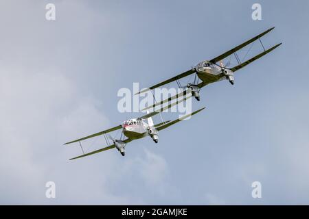 2 de Havilland Dragon Rapide ‘G-AGJG & G-AGSH’ flying in formation at Shuttleworth Flying Festival of Britain airshow on the 6th June 2021 Stock Photo