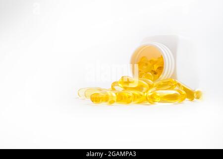 omega 3 pills pouring out of the jar on a white background Stock Photo