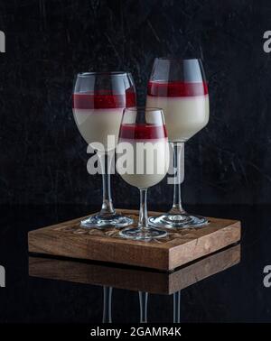 Food photography of dessert, cream, mousse, panna cotta, treat in a wineglass on a black background Stock Photo