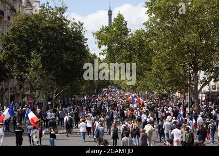 General view of Protesters next to the Eiffel Tower during a demonstration called by Les Patriotes as part of a national day of protest against French legislation making a Covid-19 health pass compulsory to visit a cafe, board a plane or travel on an inter-city train, in Paris on July 31, 2021. The legislation passed by parliament the week before has sparked mass protests in France but the government is determined to press ahead and make the health pass a key part of the fight against Covid-19. A valid health pass is generated by two jabs from a recognised vaccine, a negative coronavirus test Stock Photo