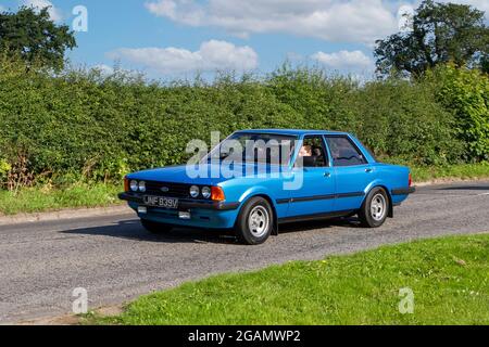 A 1980 80s Ford Cortina Gl Blue classic vintage car arriving at the Capesthorne Hall classic car show.