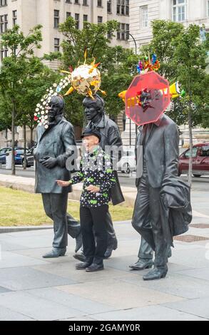 The Beatles statue by Andy Edwards is redressed by artist Stephen Jones at Pier Head in Liverpool Stock Photo