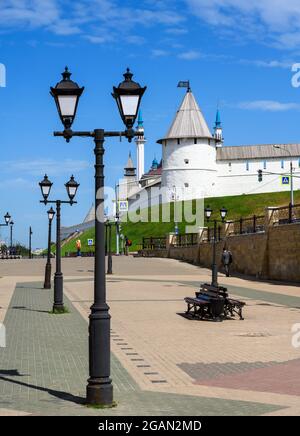 Kazan Kremlin in summer, Tatarstan, Russia. It is top landmark of Kazan. Vertical view of old white walls and retro lanterns on pedestrian Bauman stre Stock Photo