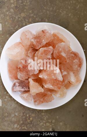 Blocks of Pink himalayan salt on white plate. Stock Photo