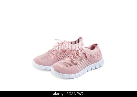 Pink women's shoes from a light soft fabric on a white background. Stock Photo