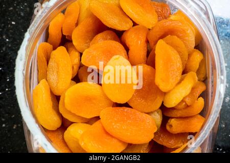 Dried Apricot (Prunus) fruit in a jar Stock Photo