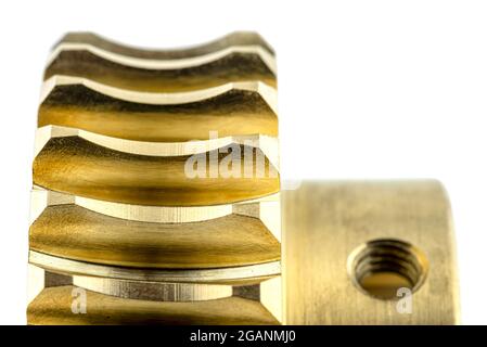 A macro photo of a new shiny copper gear, isolated on a white background, visible hole for the locking screw. Stock Photo