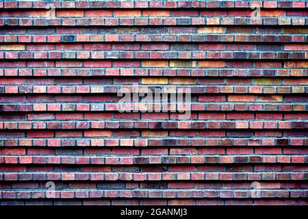 Vintage brick wall; multi-colored red bricks, textured background; urban surface Stock Photo