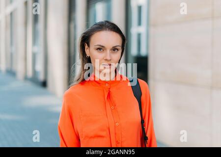 Caucasian girl looking at the camera and walking around the city. Stock Photo