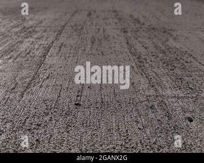 Grungy cement background with a texture of scratches and cracks made by trowel or spatula Stock Photo