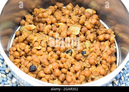 Southeast Asian, Myanmar traditional cooked yellow peas with oil. Breakfast recipe. Closeup view. Stock Photo