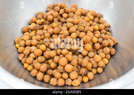 Southeast Asian, Myanmar traditional cooked yellow peas with oil. Breakfast recipe. Closeup view. Stock Photo