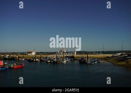 SETUBAL, PORTUGAL - Jul 04, 2021: A beautiful view  of boats at Setubal fish harbor in Portugal with blue sky background Stock Photo