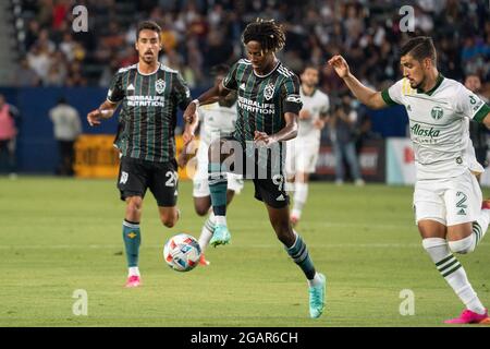 Los Angeles Galaxy forward Kevin Cabral (9) tries to control possession as Portland Timbers defender Jose van Rankin (2) defends during a MLS match, Friday, July 30, 2021, in Los Angeles, CA. The Galaxy defeated the Timbers 4-1. (Jon Endow/Image of Sport via AP) Stock Photo