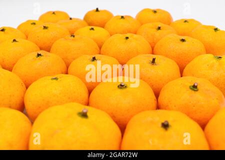 Mandarin oranges in stacks. Isolated on white background. Stock Photo