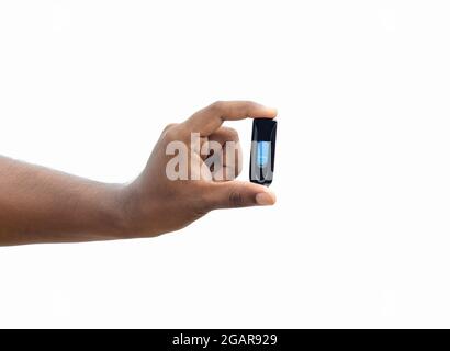 Black usb storage pendrive holding with two fingers on isolated white background Stock Photo