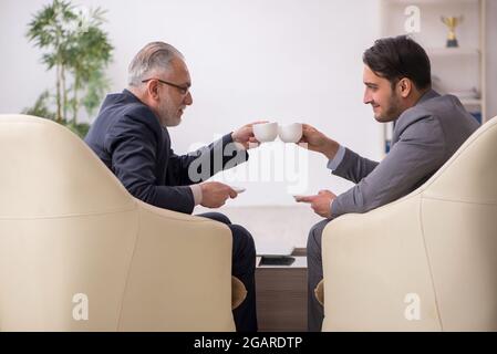 Two businessmen discussing project in the office Stock Photo