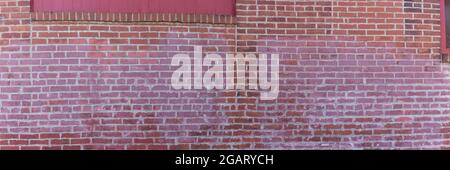 Panorama of a red brick wall with painted sections, interesting patina creative copy space, horizontal aspect Stock Photo