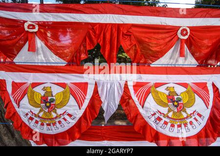 Palu, Indonesia. 01st Aug, 2021. The flag with the logo of the Republic of Indonesia is displayed on the side of Moh. Yamin Palu City, Central Sulawesi. The knick-knacks with the colors of the Indonesian flag began to be sold before the birthday of the Republic of Indonesia on August 17th. (Photo by Adi Pranata/Pacific Press) Credit: Pacific Press Media Production Corp./Alamy Live News Stock Photo