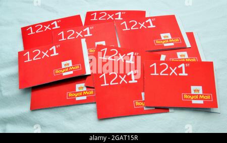 A collection of books of Royal Mail first class stamps on a white background Stock Photo