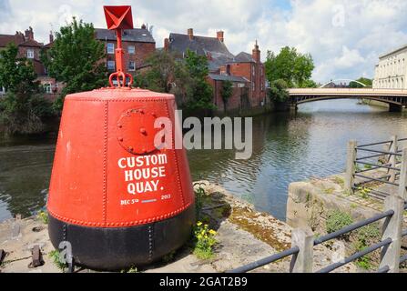 Bright red Custom House Quay buoy on the Haven riverside with town bridge in the background Stock Photo