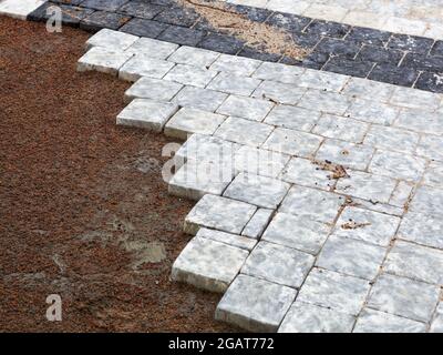 Background mosaic made of colored marble, marble tiles laying on a city street. Selective focus Stock Photo