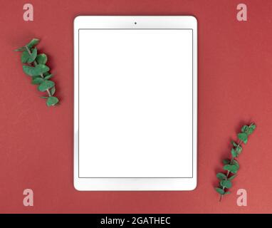 Flat lay feminine workspace with blank white screen tablet pc mockup, floral composition, copy space Stock Photo