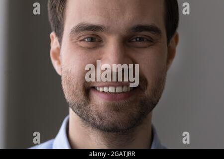 Close up cropped portrait of handsome young bearded guy face Stock Photo
