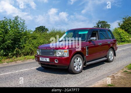 2002 red Land Rover V8 Vogue 5 speed automatic 4398cc Gas Bi-fuel en-route to Capesthorne Hall classic July car show, Cheshire, UK Stock Photo