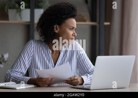 Unhappy ethnic woman feel unmotivated working on computer Stock Photo