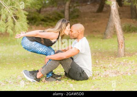 Fitness couple doing excersise while she kissing him in the nose Stock Photo