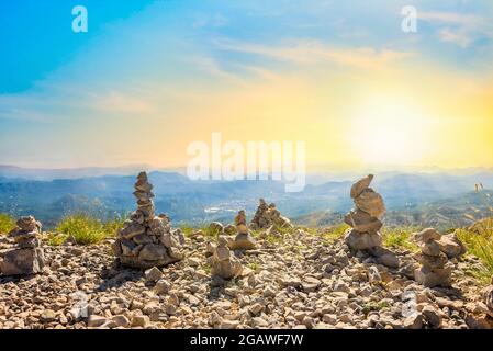 Stones stacked in towers on the top of mountains in Montenegro Stock Photo