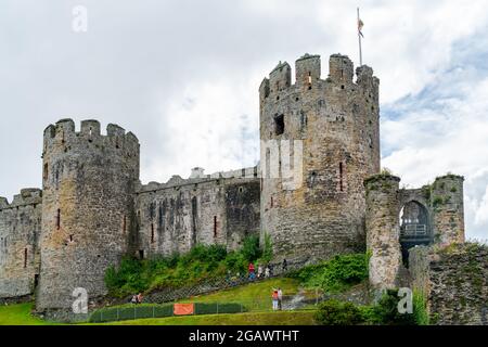 CONWY, WALES - JULY 04, 2021: Built by Edward I between 1283 and 1289, the famous 13th century Conwy Castle is a popular tourist attraction Stock Photo