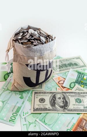 pouch with coins and bitcoins on us dollar and euro banknotes Stock Photo