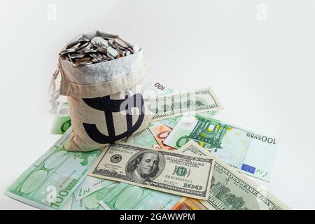 pouch with coins and bitcoins on us dollar and euro banknotes Stock Photo