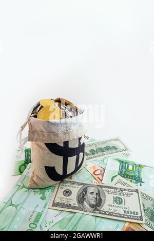 pouch with coins and bitcoins on us dollar and euro banknotes Stock Photo