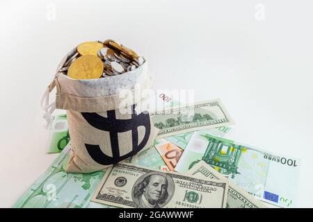 pouch with coins and bitcoins on us dollar and euro banknotes Stock Photo