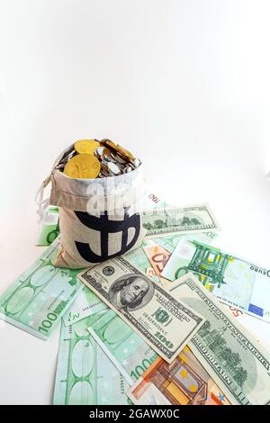 pouch with coins and bitcoins on us dollar and euro banknotes Stock Photo