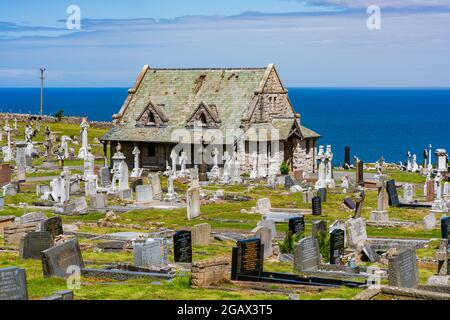 LLANDUDNO, WALES - JULY 05, 2021: St. Tudno's Chapel surrounded by Great Orme Cemetery on Great Orme headland Stock Photo