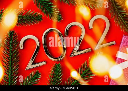 2022 New Year and Christmas celebration. Composition with numbers, gift box and blurry lights Stock Photo