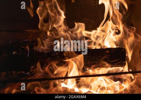 BBQ Fireplace Traditional Cooking on Open Fire Burning Firewood in the Brazier Stock Photo