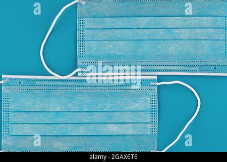 medical protective face mask on blue background Stock Photo