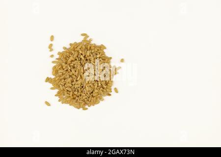 pile of brown rice on white background. close-up of brown rice top view Stock Photo