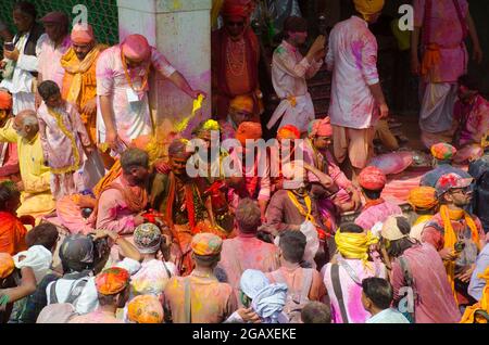 Pilgrims and priests are playing colors in a temple in Mathura, India
