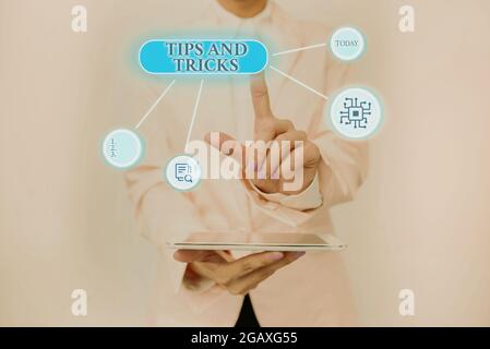 Sign displaying Tips And Tricks, Word Written on piece of inside facts specially in betting or investing Lady Holding Tablet Pressing On Virtual Butto Stock Photo