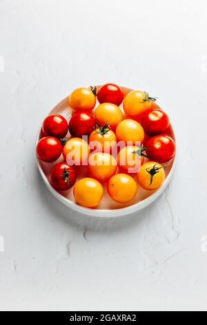 Plate of Ripe Red and Yellow Cherry Tomatoes on a White Background, Isolated – FOODPIX WHITE - COPYSPACE - ROOM FOR TEXT Stock Photo